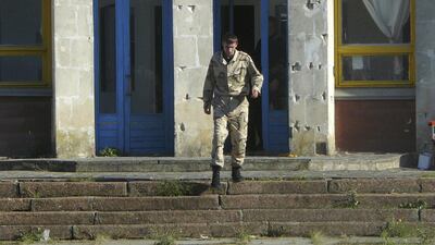 A defence force guards and chases away any would-be visitors at the Dobrobut farm in Grabovo, Crimea. Dobrobut was one of dozens of businesses to be forcibly taken over this year by Crimea’s pro-Moscow leaders. Alexander Zemlianichenko / AP Photo