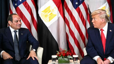 US President Donald Trump speaks with Egypt's President Abdel Fattah El Sisi during their meeting on the sidelines of the World Economic Forum in Davos on January 21, 2026. AFP