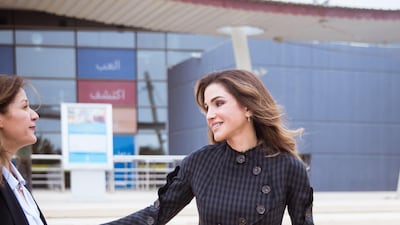 Queen Rania of Jordan wore a top by A.W.A.K.E. and carried a navy blue bag by Halm. Courtesy Halm