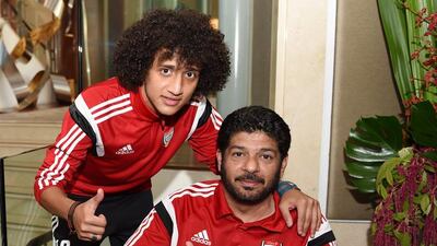Omar Abdulrahman and a member of the back-room staff give their thumbs up.