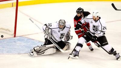 Jonathan Quick of the Los Angeles Kings allows a goal as Stephen Gionta and Colin Fraser look on