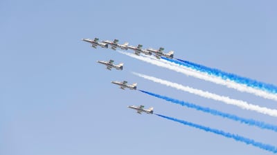 The seven gold and black Aermacchi MB-399A jet aircraft soars over Abu Dhabi Corniche. Antonie Robertson / The National