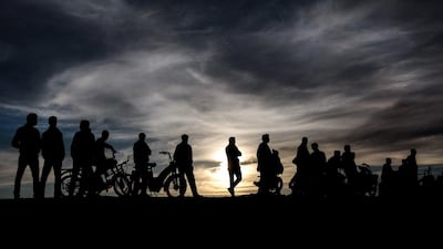 Amazigh boys watch a football game on February 3, 2016, photo, from a hill in a locally organised tournament between tribes in Kelaat M’Gouna town, southern Morocco.