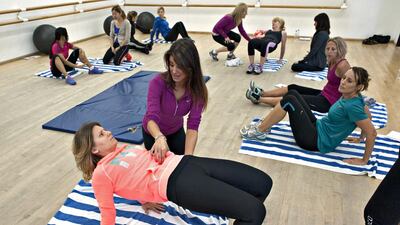 Personal trainer Robyn Ablott gives instructions to trainer Monica Nicolae during a class on pre and post natal fitness put on by Impact BTS, in Dubai City. Jeff Topping for The National