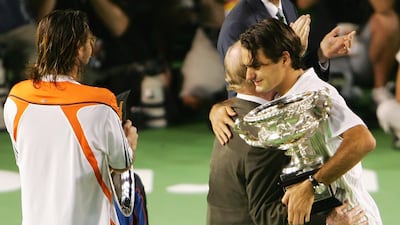 Roger Federer of Switzerland hugs Rod Laver after victory in 2006. Getty
