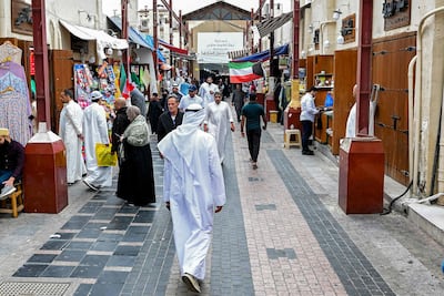 People walk along an alley at a traditional market in Kuwait City. AFP