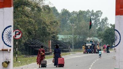 Bangladeshi families cross to the Indian side of the Fulbari border checkpoint in March 2021. Dhaka has extended the current border closures with India until June 30. AFP