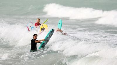 Standalone. People surf the waves on a blustery windy day in Dubai. Chris Whiteoak / The National