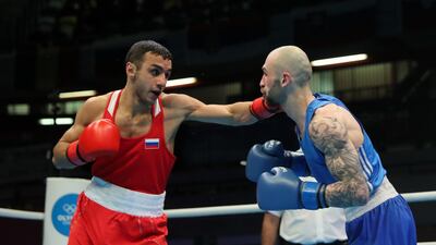 Russia's Gabil Mamedov, left, lands a punch on Lasha Guruli of Georgia during the men's lightweight preliminary round bout during the Olympic boxing qualifiers at Copper Box Arena in London. Getty