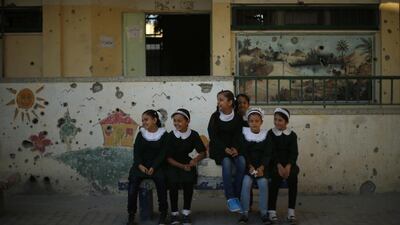 Palestinian students sit inside their school, walls bearing the marks of Israel’s 50-day war with Gaza. Suhaib Salem/Reuters