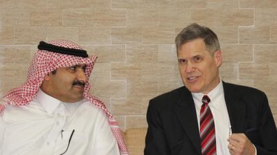 Saudi Ambassador to Yemen Mohammed Bin Saeed Al-Jaber, left, and his US counterpart Matthew H Tueller speak as they arrive at Mukalla airport, in Yemen. AFP