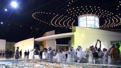 Visitors look at a model of King Abdullah University of Science and Technology displayed at the opening ceremony of the university in Jeddah.