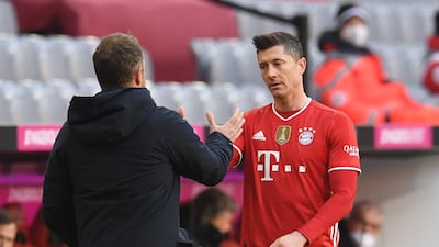 Bayern Munich's Robert Lewandowski shakes hands with coach Hansi Flick. Reuters