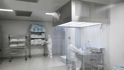 Two engineers work during a media tour of a new factory built to produce a Covid-19 vaccine at Sinovac in Beijing. AFP