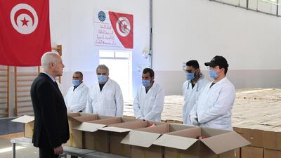 President Kais Saied takes part in the distribution of aid packages in Gammarth town on the outskirts of Tunis. AFP