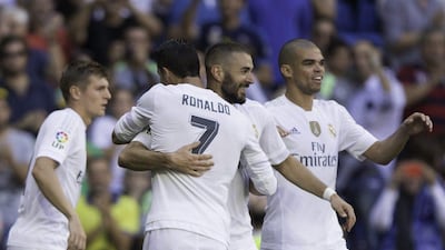 Karim Benzema, centre, is congratulated by teammates after scoring the only goal of Real Madrid's win over Granada. Gonzalo Arroyo Moreno / Getty Images