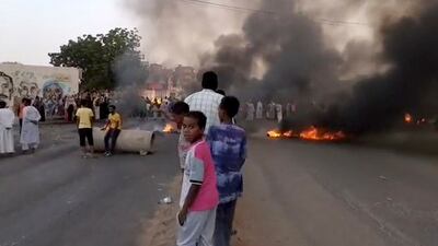 Smoke and fire on the streets of Khartoum as people took the streets after reports of a coup. Reuters