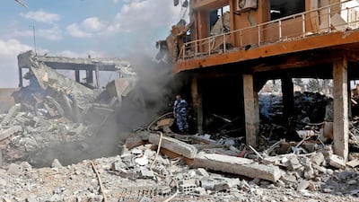A Syrian soldier inspects the wreckage of a building described as part of the Scientific Studies and Research Centre (SSRC) compound in the Barzeh district, north of Damascus, during a press tour organised by the Syrian information ministry, on April 14, 2018. The United States, Britain and France launched strikes against Syrian President Bashar al-Assad's regime early on April 14 in response to an alleged chemical weapons attack after mulling military action for nearly a week. Syrian state news agency SANA reported several missiles hit a research centre in Barzeh, north of Damascus, "destroying a building that included scientific labs and a training centre". AFP PHOTO / LOUAI BESHARA