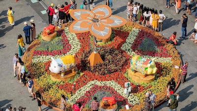 Visitors pose for photographs in front of pig figurines at the Nguyen Hue flower street, decorated for the upcoming Lunar New Year or Tet celebrations in Ho Chi Minh City. AFP