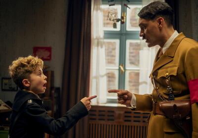 Roman Griffin Davis and Taika Waititi in a scene from the WWII satirical film 'Jojo Rabbit.' AP