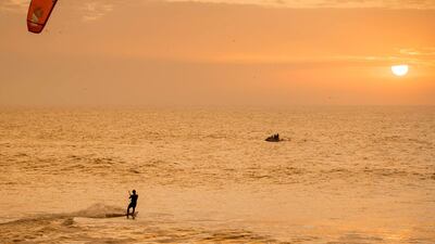 A kitesurfer at sunset. AFP