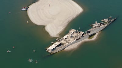 People swimming near a sunken German warship from World War II, exposed due to low Danube River levels caused by drought and extreme heat, in Prahovo, Serbia. Reuters