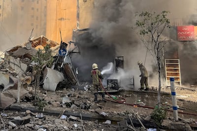 Firefighters put out a fire after an Israeli attack on Beirut’s southern suburbs. AFP
