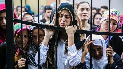 Women react during the funeral of a victim of the failed July 15 coup attempt in Istanbul. Turkish President Recep Tayyip Erdogan vowed to purge the “virus” within state bodies, during a speech at the funeral of victims killed during the coup bid he blames on his enemy Fethullah Gulen. Gurcan Ozturk / AFP