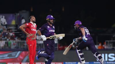 Oman's bowler Fayyaz Butt, left, reacts as Scotland's captain Kyle Coetzer, middle, and teammate George Munsey run between wickets in Muscat. AP