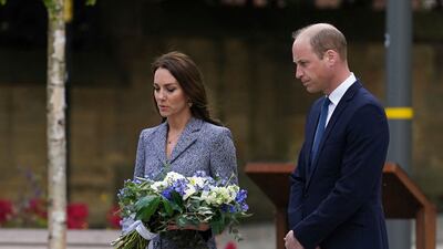 Prince William and Kate lay flowers at the Glade of Light memorial. AFP