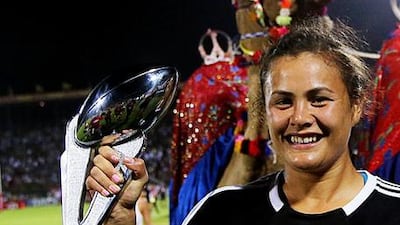 Charlotte Scanlan of New Zealand team celebrates with the trophy after winning the Women's Sevens World Series finals at the Rugby Sevens Series at The Sevens grounds in Dubai. Satish Kumar / The National