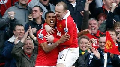 Manchester United's Wayne Rooney congratulates team mate Nani after he scored against Manchester City .