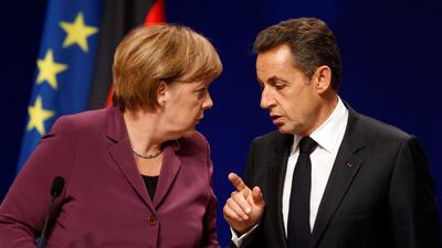 In this Wednesday, Nov. 2, 2011 file photo, German Chancellor Angela Merkel, left, and French President Nicolas Sarkozy chat during a joint news conference at the G20 in Cannes, France. This photo is one of a series of ten selected Associated Press photos???