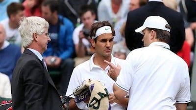 Roger Federer required some physio to overcome a balky back issue but eventually defeated Xavier Malisse.