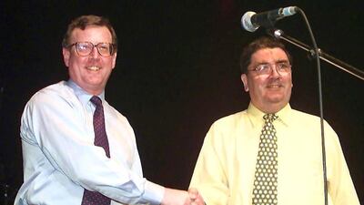 In this file photo taken on May 19, 1998 showing Ulster Unionist leader David Trimble, left, and John Hume shaking hands on stage during a concert given by U2 in Belfast to campaign for a Yes vote for the Good Friday Agreement peace referendum in Northern Ireland. AFP