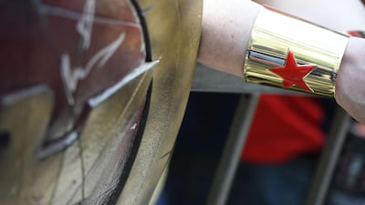 A fan wearing a Wonder Woman bracelet waits to meet actress Lynda Carter (not in photo) at her star unveiling ceremony on the Hollywood Walk of Fame. Robyn Beck / AFP