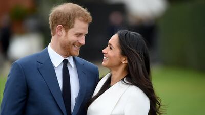 Prince Harry pose and Ms Markle smile at each other during the photocall. Facundo Arrizabalaga / EPA