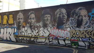 A portrait mural and graffiti in Shoreditch. Photo by Rosemary Behan