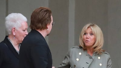 Brigitte, wearing a slate jacket with gold button detail, and Irish U2 star Bono at the Elysee Palace on July 24, 2017. AFP