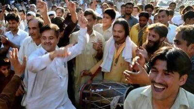 Pakistani people dance as they celebrate a Supreme Court's decision to disqualify former Prime Minister Yusuf Raza Gilani.