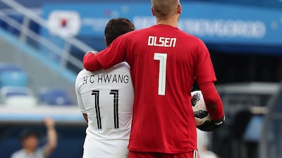 Hwang Hee-chan of South Korea, left, and goalkeeper Robin Olsen of Sweden. Vassil Donev / EPA