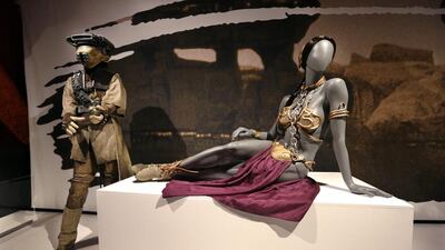 Princess Leia’s slave bikini, right, and her Boushh disguise. AP
