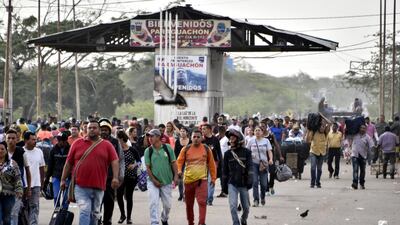 Venezuelans walk crossing the border from Venezuela to Colombia on June 8, 2019 in Paraguachon, Colombia. Getty