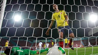 Colombia goalkeeper Cristian Bonilla, left, and Jose Leudo react after South Korea's Song Ju-hun scored the opening goal on Wednesday night. Armando Franca / AP Photo