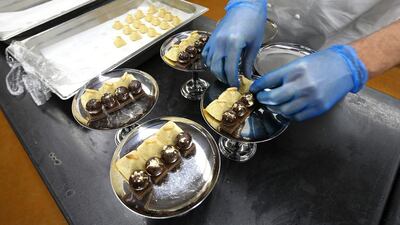 A chef prepares food items in the bakery section. Pawan Singh / The National