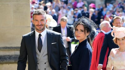 David, in Dior Homme, and Victoria Beckham attend the wedding of Prince Harry and Meghan Markle on May 19, 2018 in Windsor, England. Getty Images