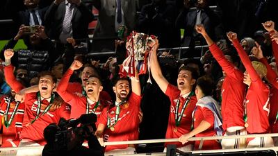 Manchester United's Bruno Fernandes and Harry Maguire lift the trophy. Reuters