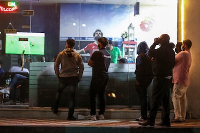 Fans in Abu Dhabi watching the Africa Cup of Nations in February. Shisha cafes will be popular venues for fans watching the World Cup this year. Khushnum Bhandari / The National