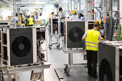 Electric heat pumps extract warmth from the ground or air outside and are part of the UK's push to cut emissions. AFP