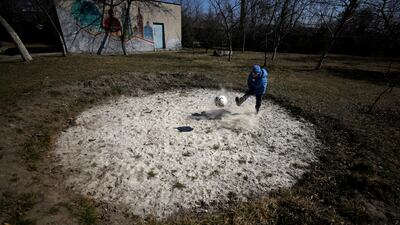 Mykhaylo, 8, who was taken away from his widowed mother along with his 9-year-old brother and 16-year-old sister, plays with a ball in the garden of a state shelter in Lviv. Reuters